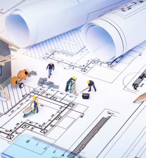 house under construction on blueprints - building project